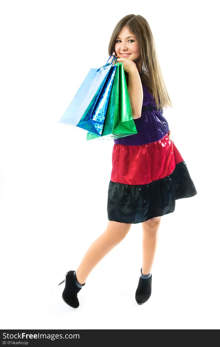 Beautiful young woman holding shopping bags against white background. Beautiful young woman holding shopping bags against white background