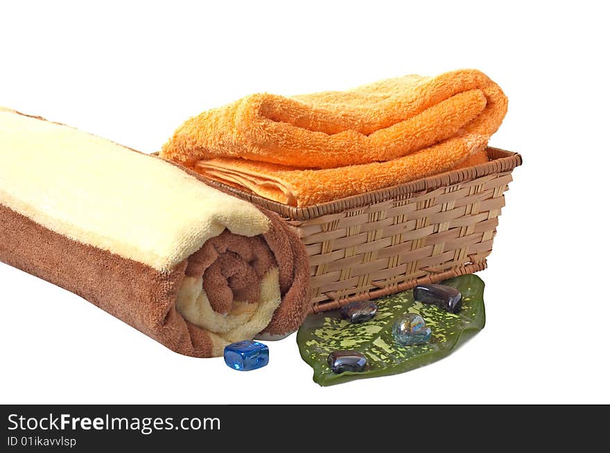 Towels with wonderful stones,green leaf and basket isolated on a white background.