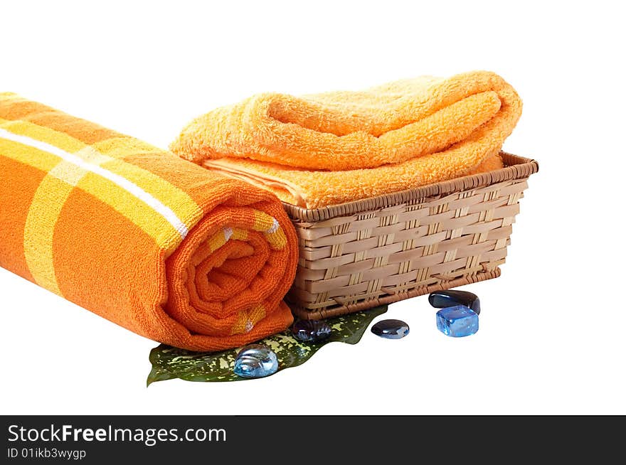 Towels with wonderful stones,green leaf and basket isolated on a white background. Towels with wonderful stones,green leaf and basket isolated on a white background.