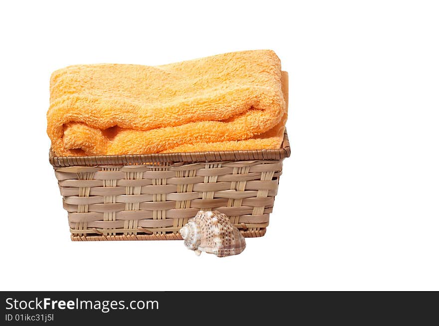 Towel in the basket and seashell isolated on a white background. Towel in the basket and seashell isolated on a white background.