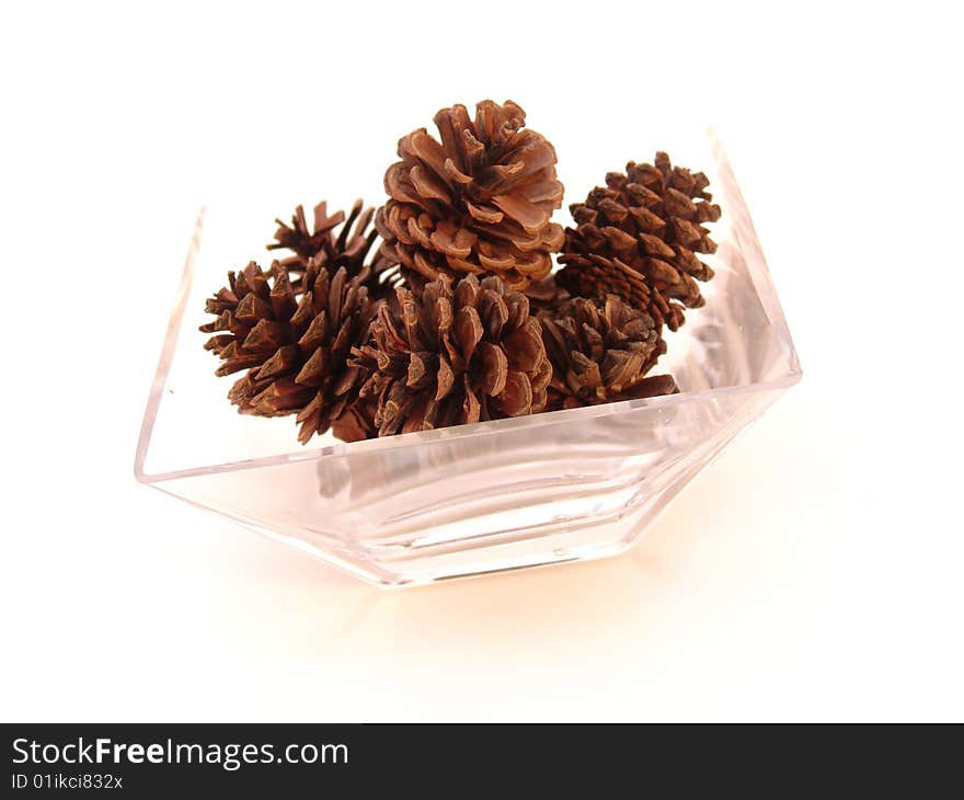 Pine cones in glass dish