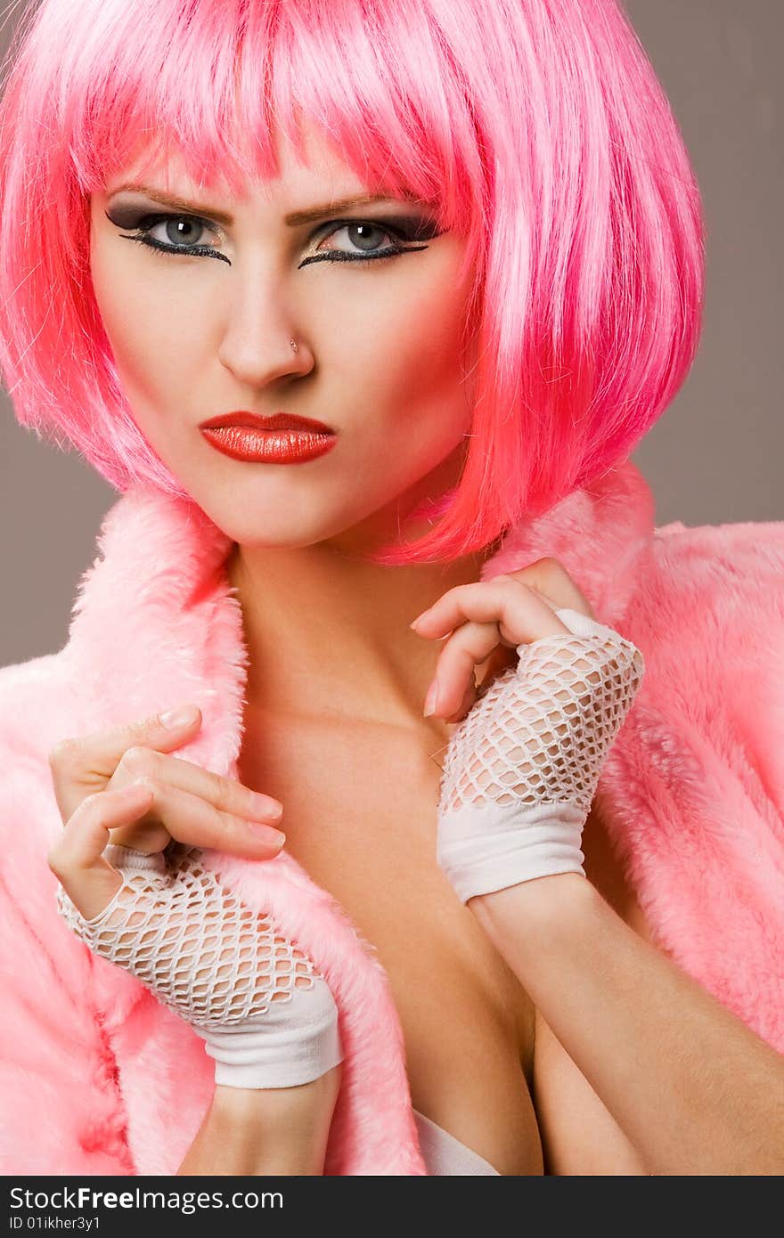 Attractive woman wearing red fur coat and magenta wig. Attractive woman wearing red fur coat and magenta wig