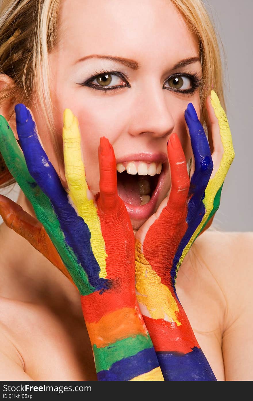 Pretty female model with hands painted rainbow style. Pretty female model with hands painted rainbow style