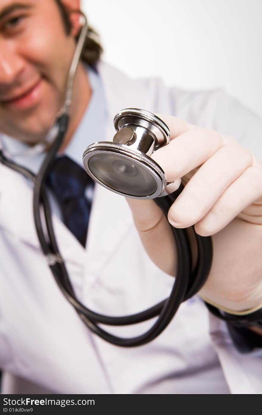 Smiling doctor with stethoscope over white. Smiling doctor with stethoscope over white