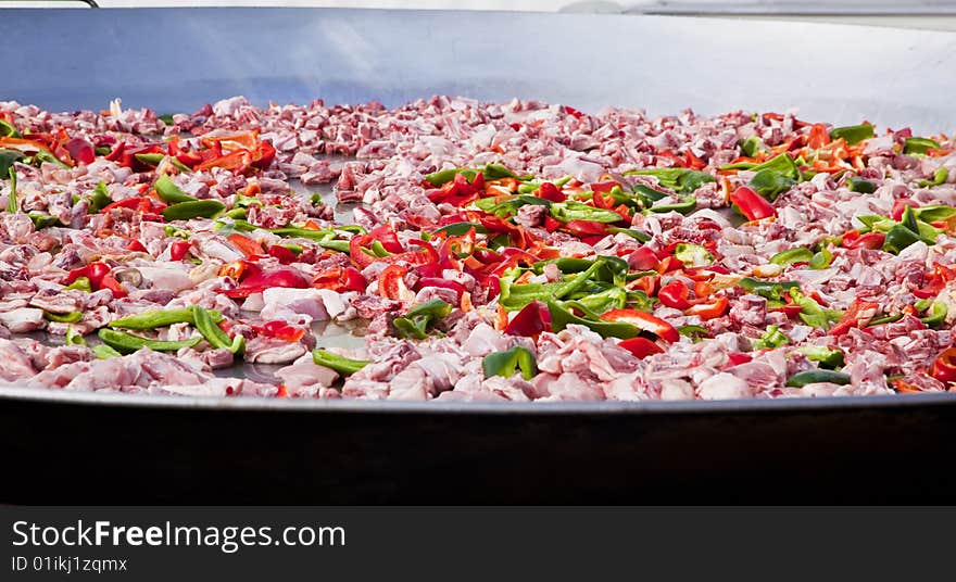 Huge frying pan closeup with lots of ingredients