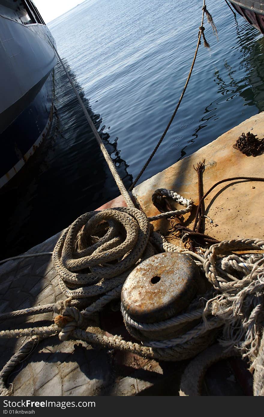 Boat mooring and rope in a harbor .