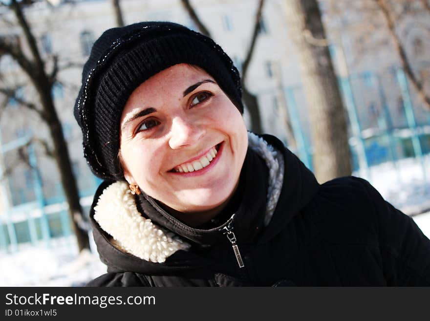 Young woman is smailing outside