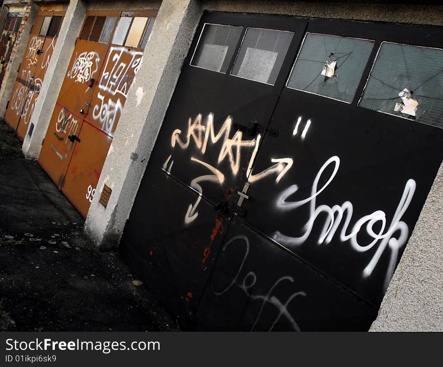 Angled shot of garage doors vandalized and marred with graffiti. Taken in Prague. Angled shot of garage doors vandalized and marred with graffiti. Taken in Prague.