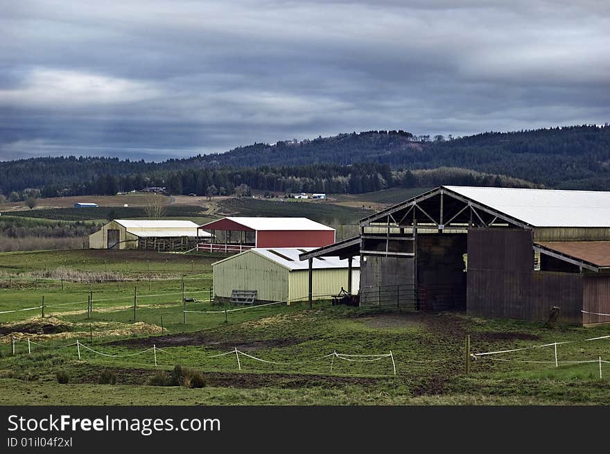 A nice farmland day in Oregon with stables and corrals.