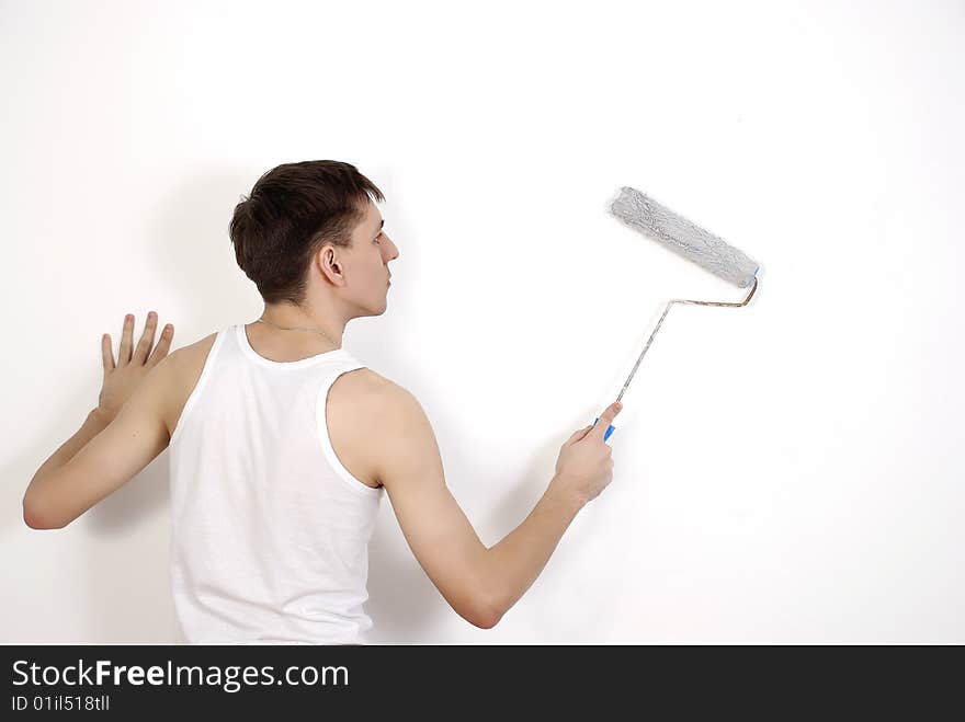 The man painting a wall by the white platen