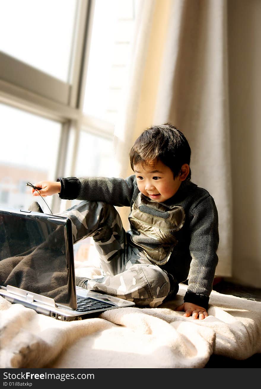 Boy Playing With Notebook