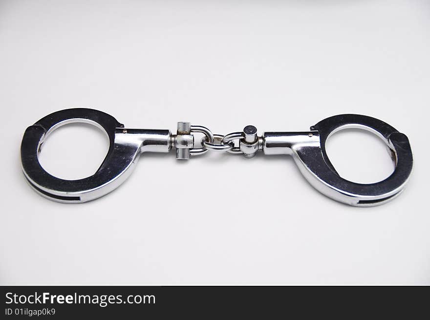 A close-up of handcuff with white background.