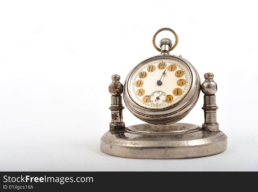 An old fashioned clock on white background. An old fashioned clock on white background