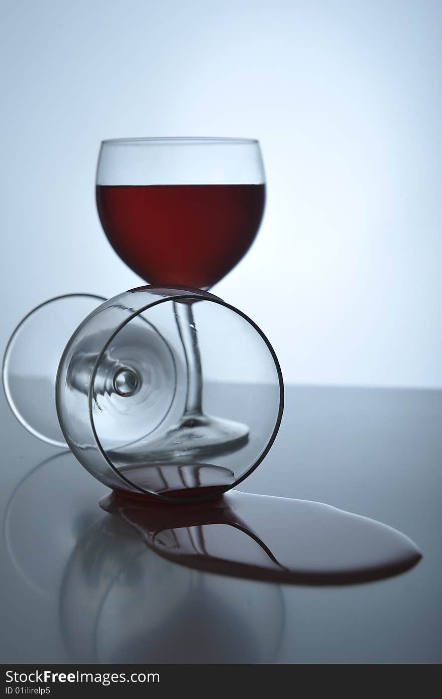 Red wine spilling out from a wineglass, close up. Red wine spilling out from a wineglass, close up