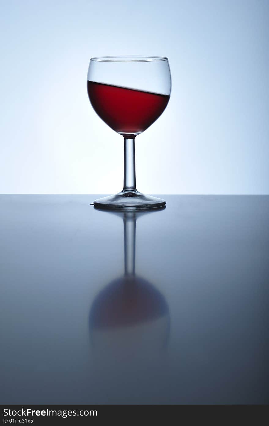 Glass with red wine standing oblique, close up. Glass with red wine standing oblique, close up