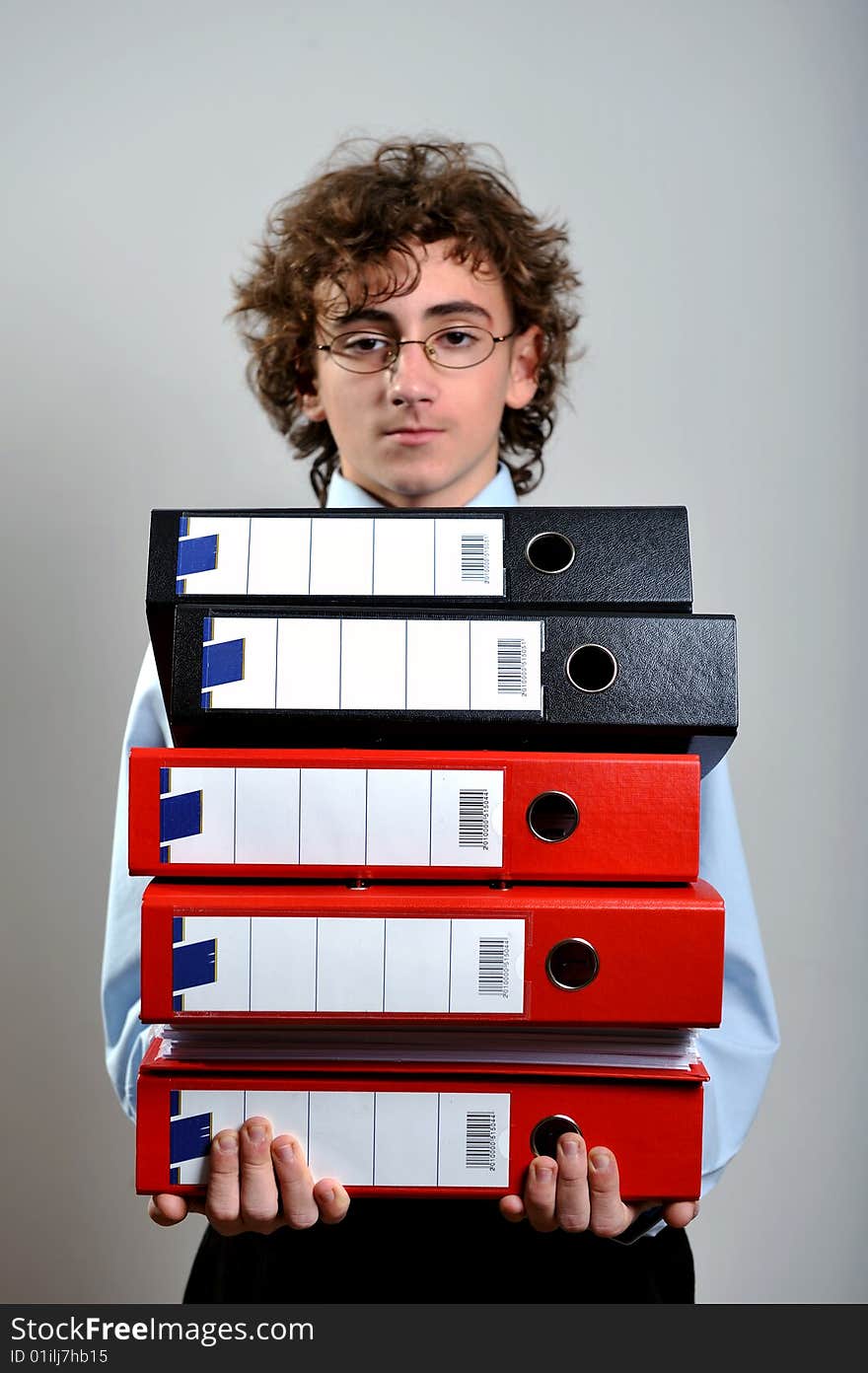 Young businessman holding a stack of folder in his hands. Young businessman holding a stack of folder in his hands