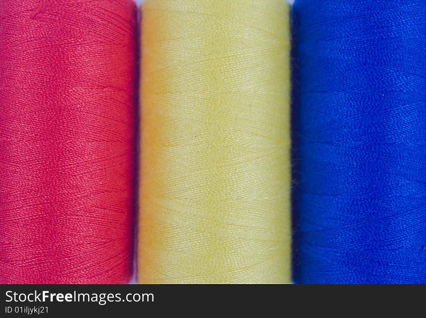 Three colored sewing spools