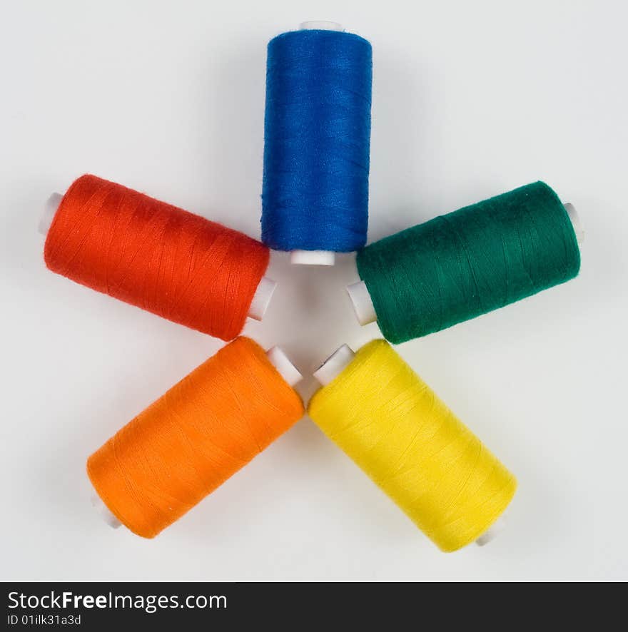 Five colored sewing spools