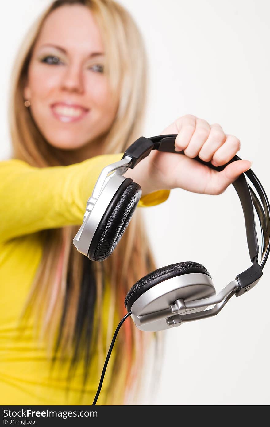 Attractive young woman with headphones over white