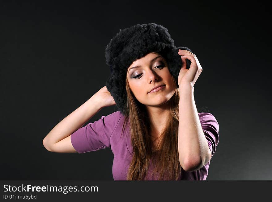 Woman in a fancy russian hat over black