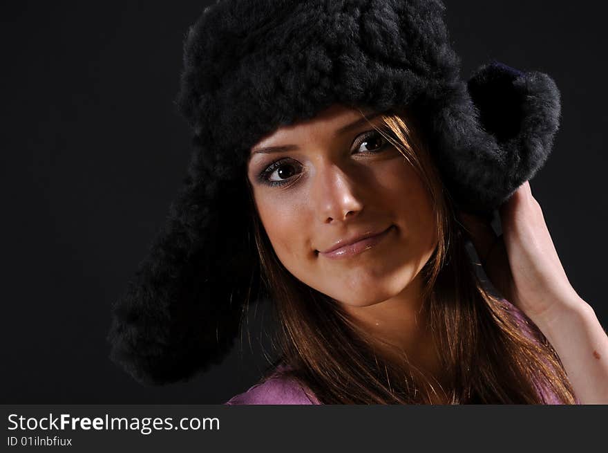 Woman in a fancy russian hat over black