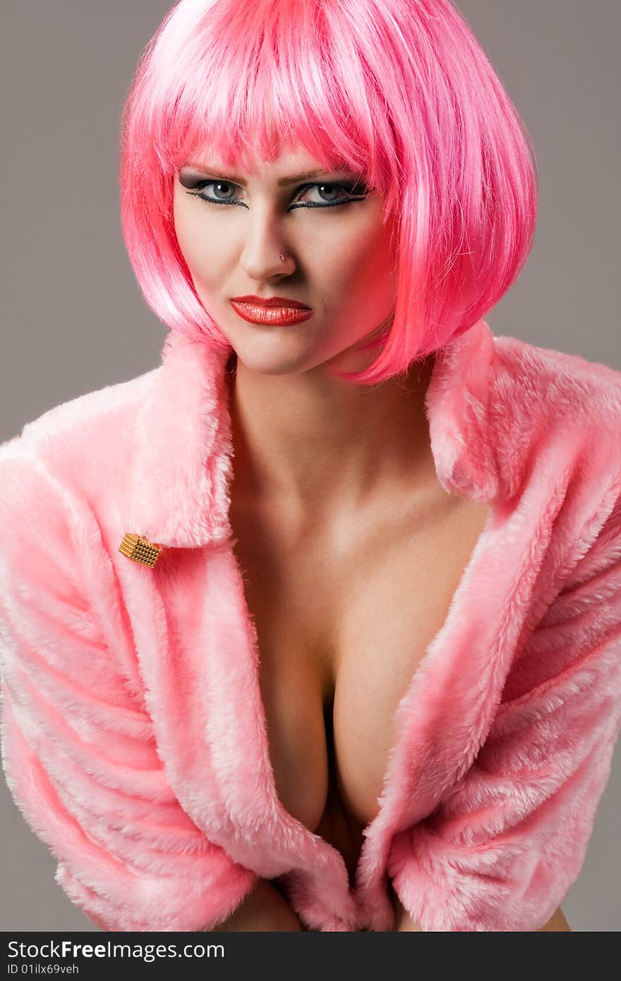 Attractive woman wearing red fur coat and magenta wig. Attractive woman wearing red fur coat and magenta wig