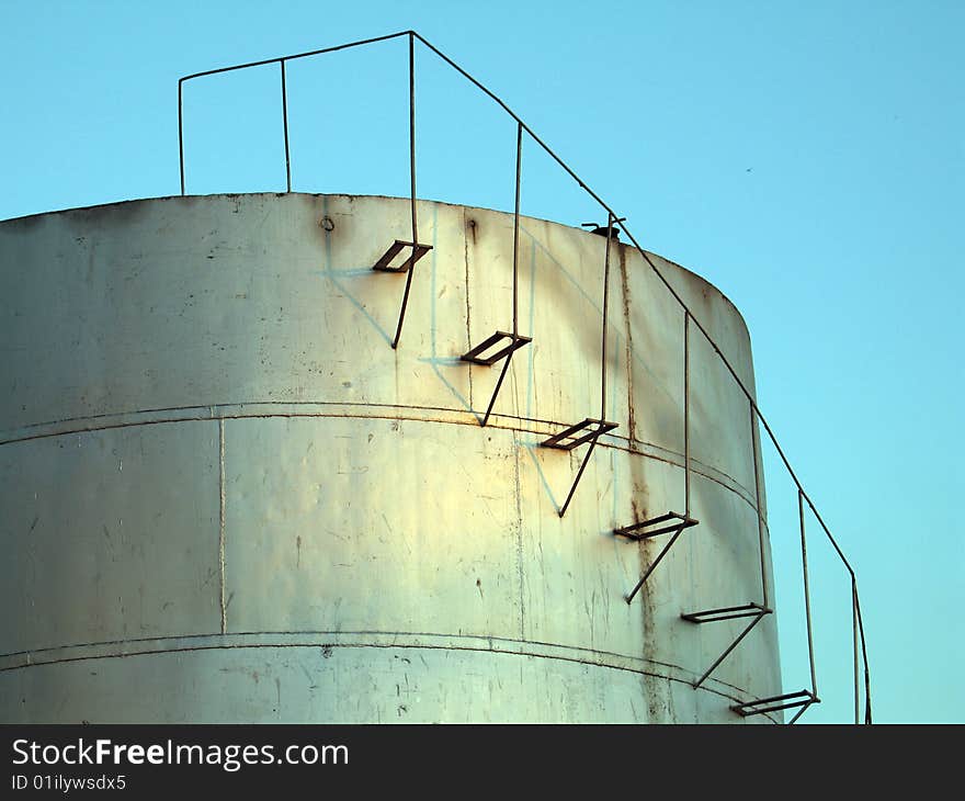 Cylindrical fuel storage tanks with staircase running along the side