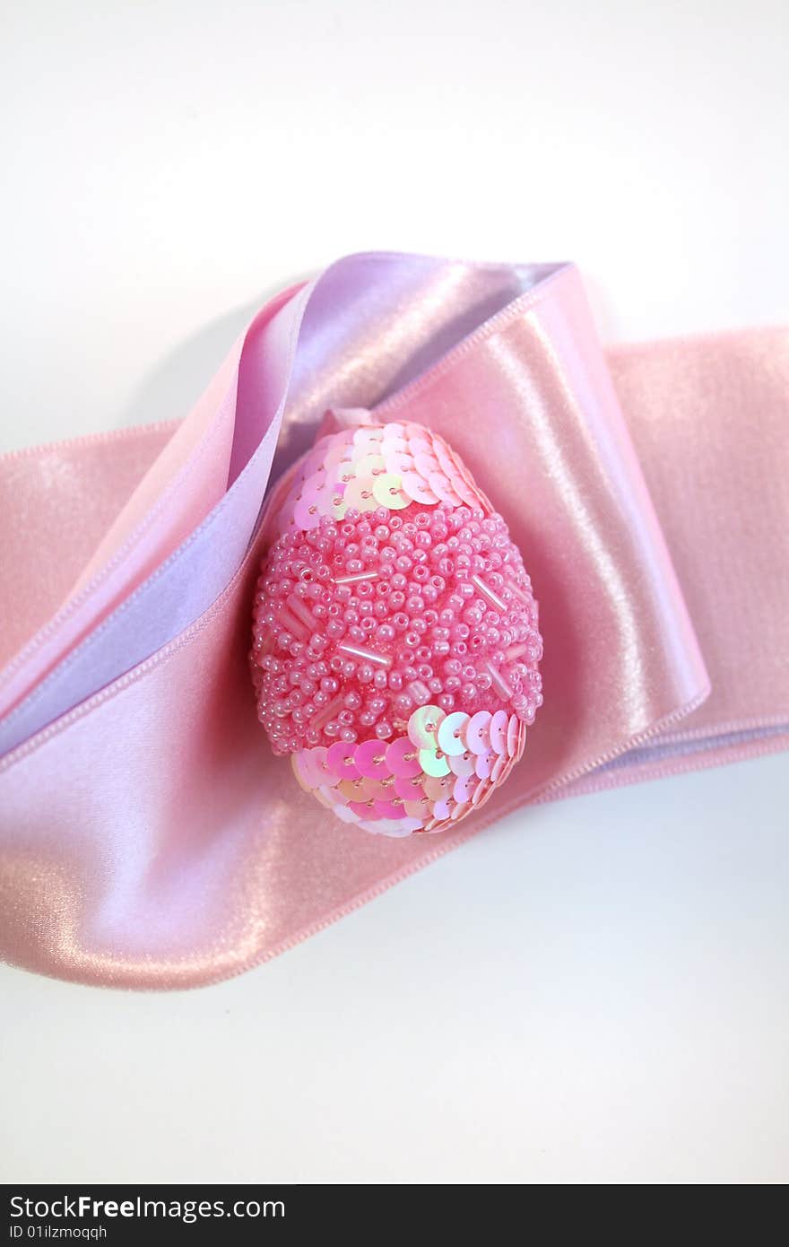 Pink easter  egg decorated a ribbon