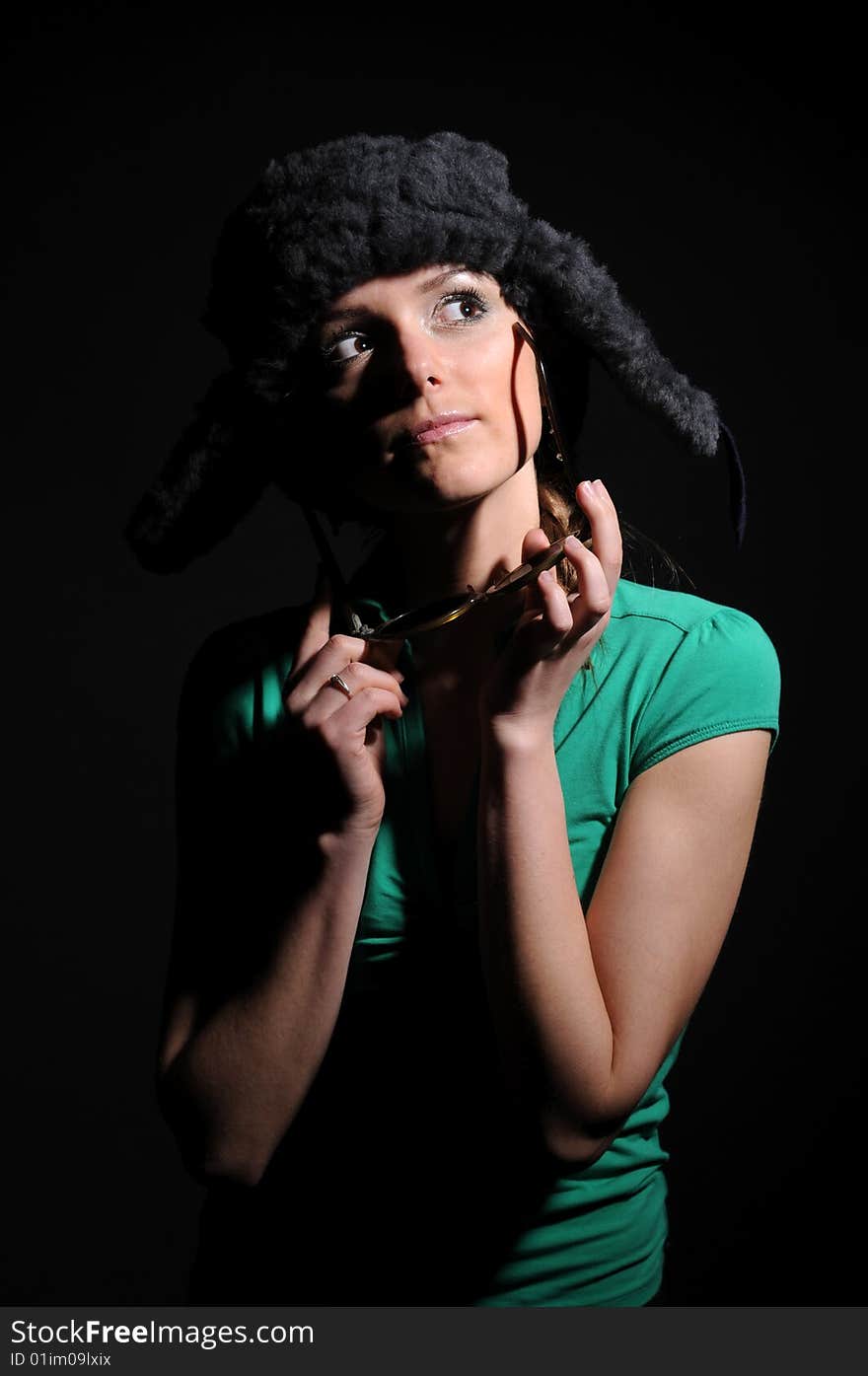 Woman in a fancy russian hat over black