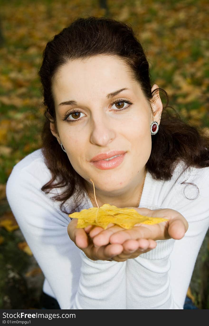 Portrait of pretty girl with autumn leaf