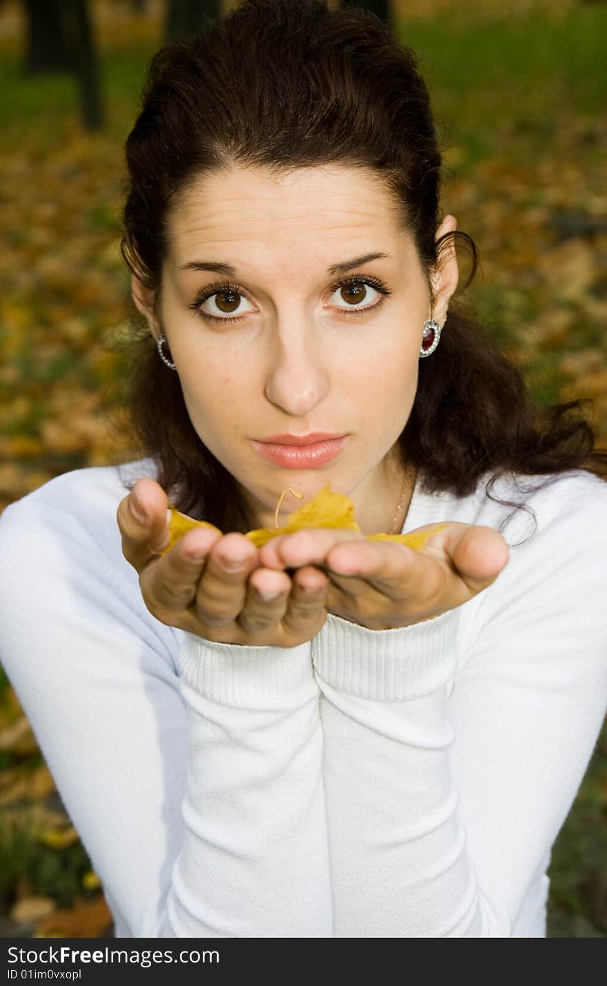 Portrait of pretty girl with autumn leaf