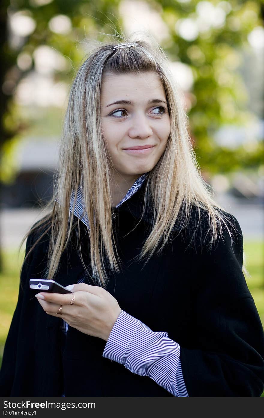 Portrait of cute young girl with phone