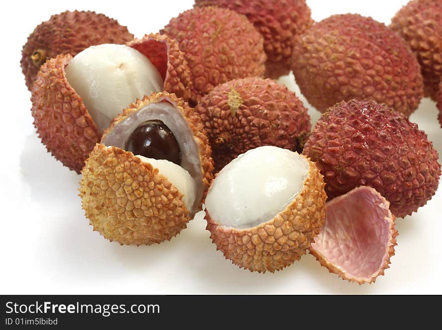 Closeup of fresh litchis over white background