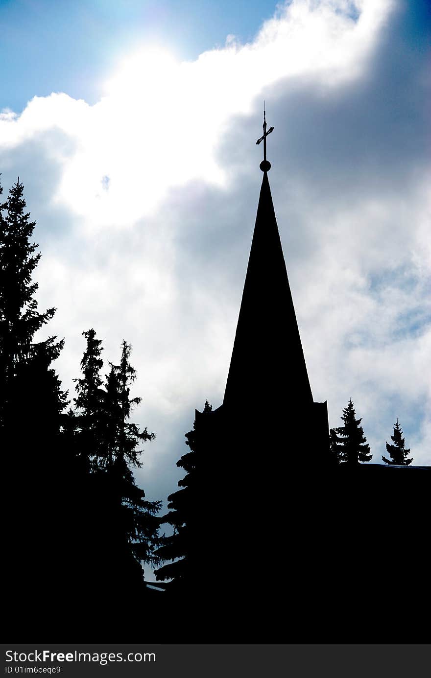 View of the tower of a church with backlighting effeect. View of the tower of a church with backlighting effeect.