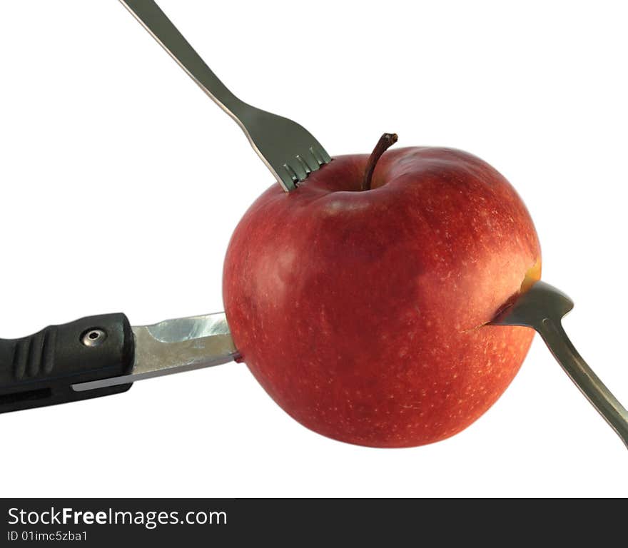 Drive a knife, spoon and fork into the apple. Drive a knife, spoon and fork into the apple