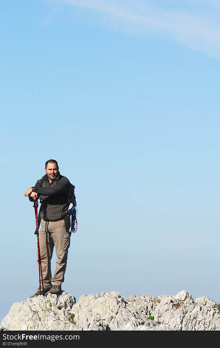 Man in a top of a in mountain hiking