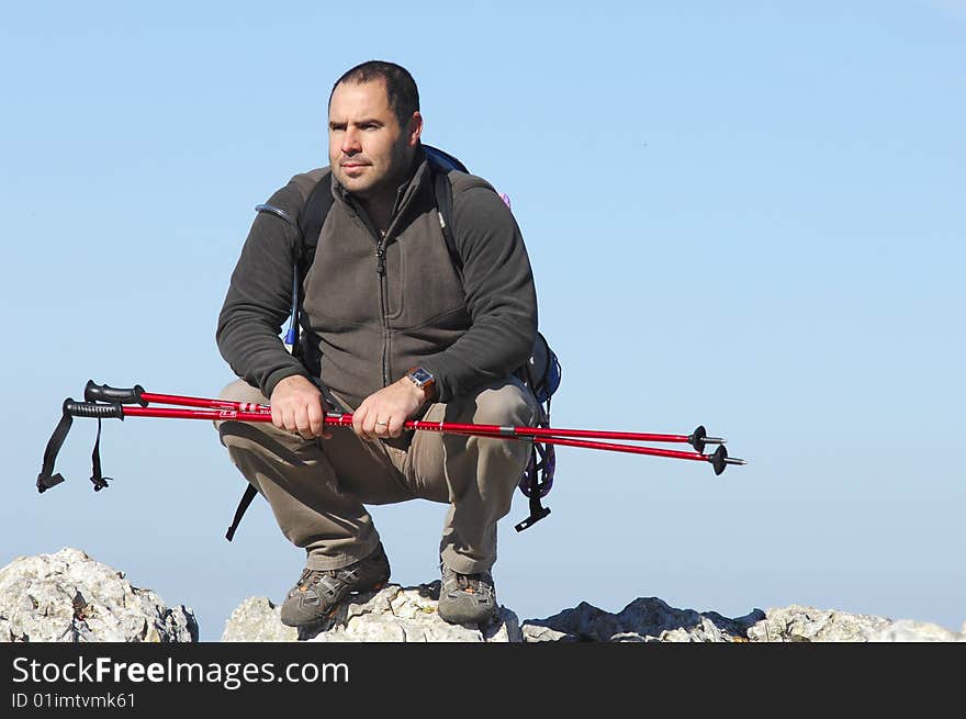 Man in a top of a in mountain hiking