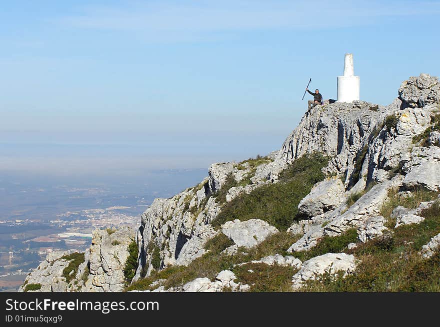 Man in a top of a in mountain hiking