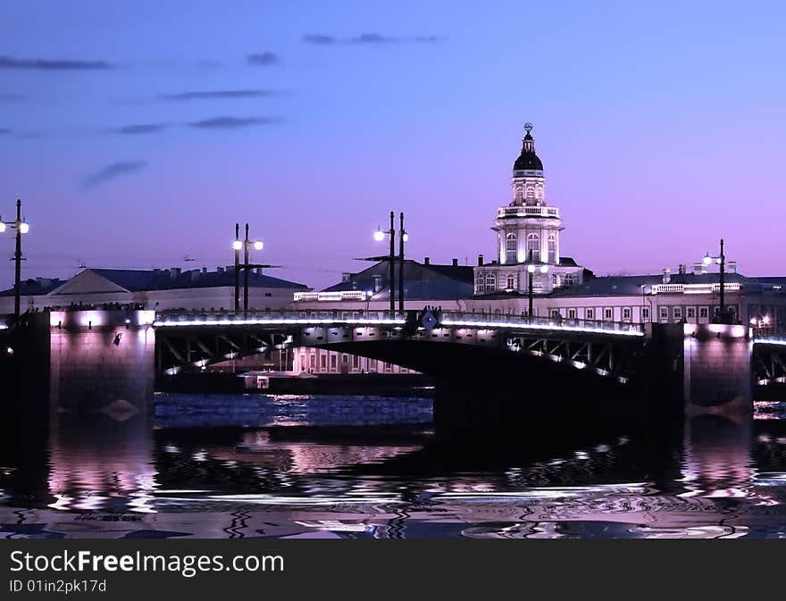 Image of a night city plot. The bridge through the river.