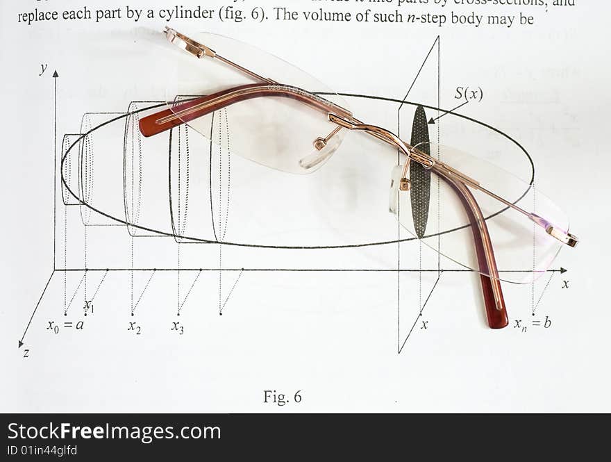 A pair of glasses on a maths teach book. A pair of glasses on a maths teach book