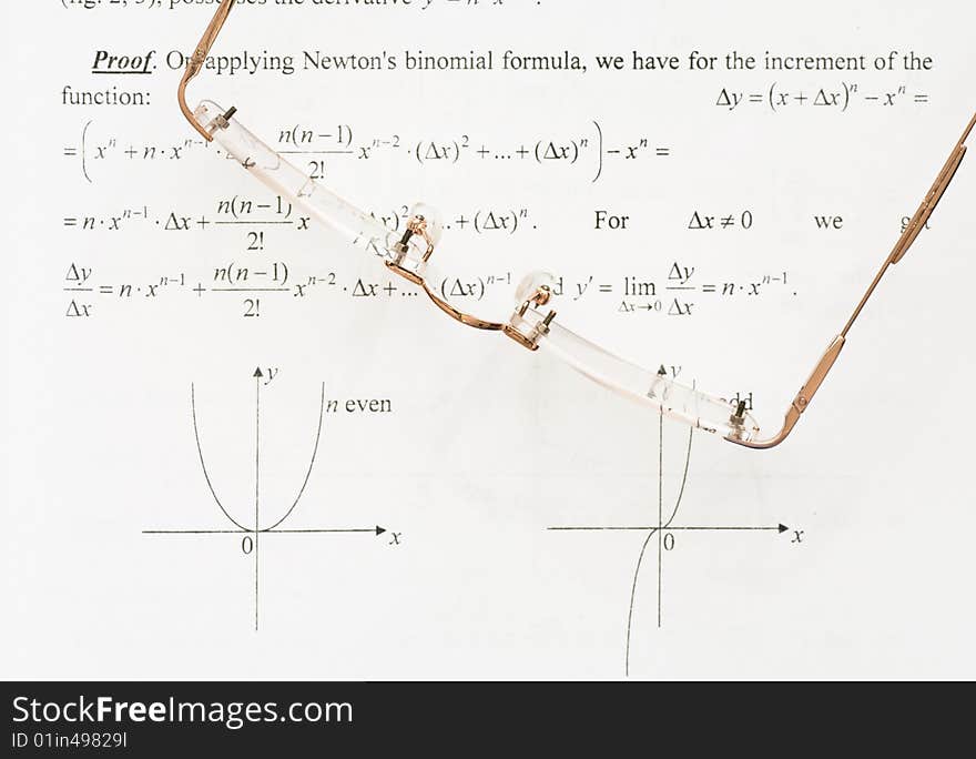 A pair of glasses on a maths teach book. A pair of glasses on a maths teach book