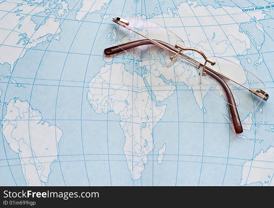 A pair of glasses on a geography atlas. A pair of glasses on a geography atlas