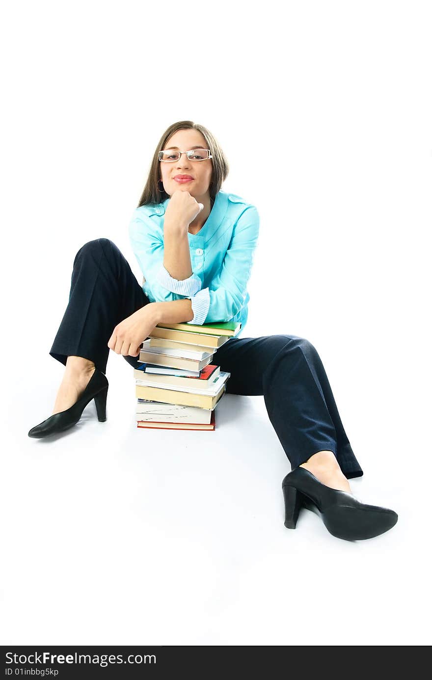 Young student sitting on the floor with a lot of books. Young student sitting on the floor with a lot of books