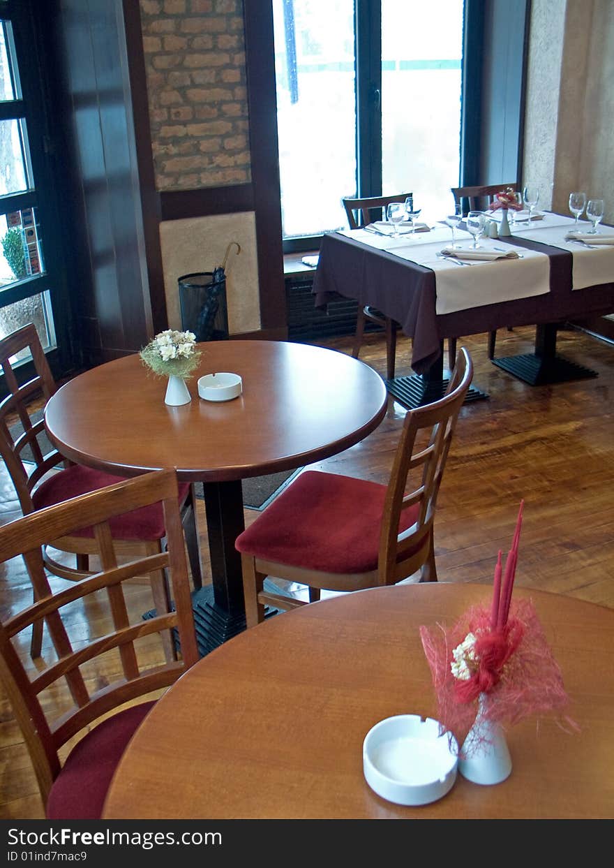 Round tables with ashtray and flower in restaurant. Round tables with ashtray and flower in restaurant