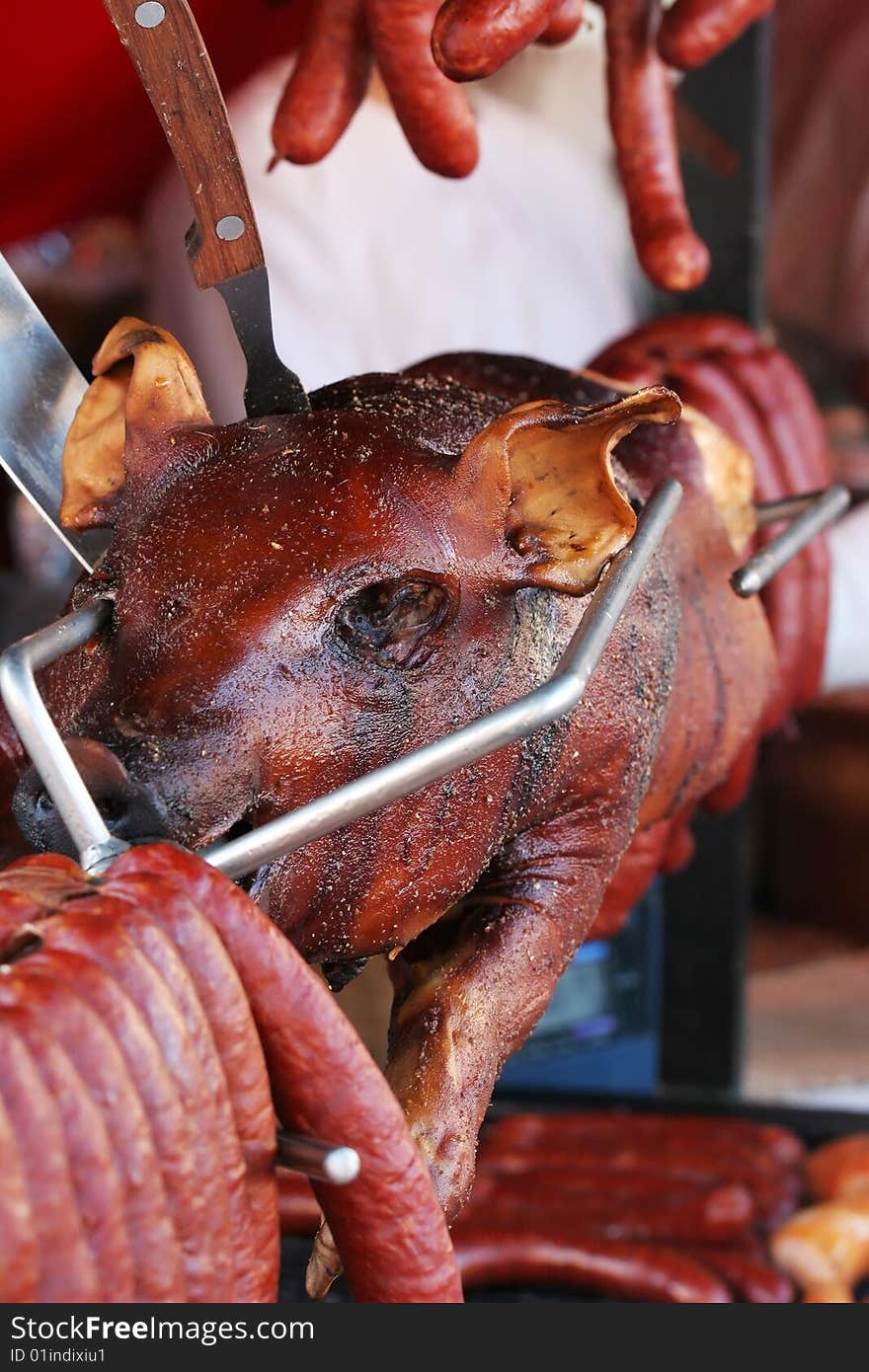 Baked pig on the grill with the fork