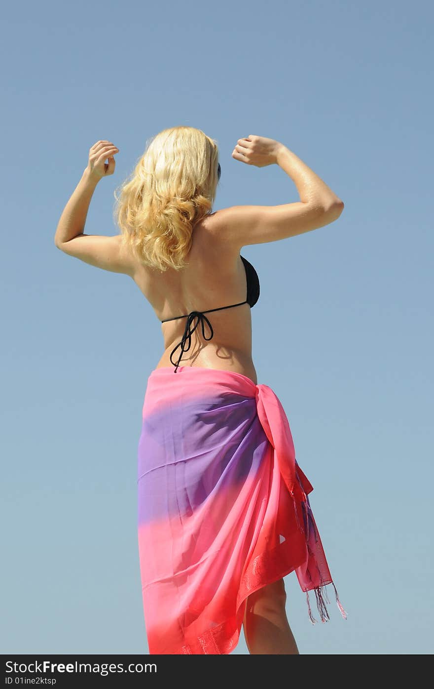 Young woman enjoying the summer by the swimming pool. Young woman enjoying the summer by the swimming pool.