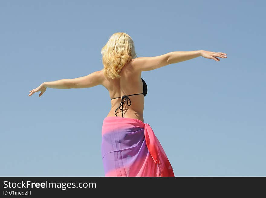 Young woman enjoying the summer by the swimming pool. Young woman enjoying the summer by the swimming pool.