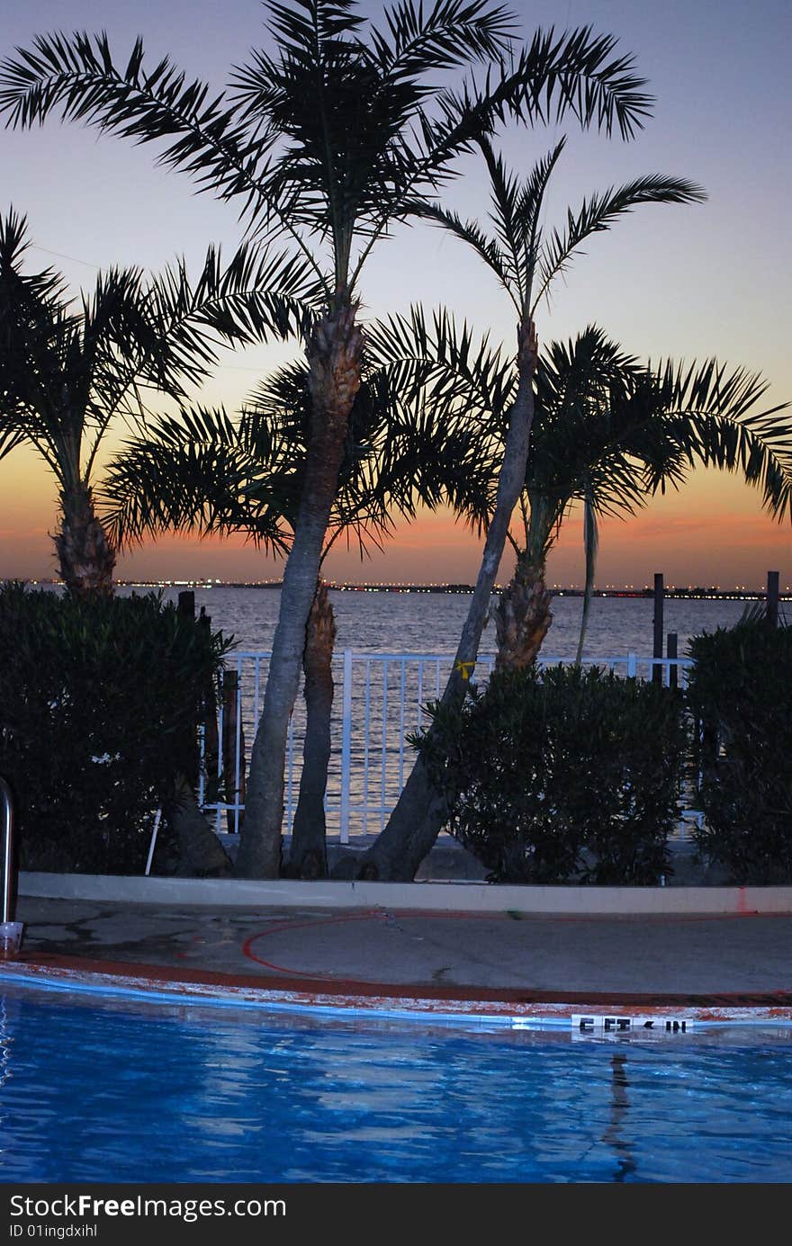 Looking over the pool into the bay at sunset. Looking over the pool into the bay at sunset