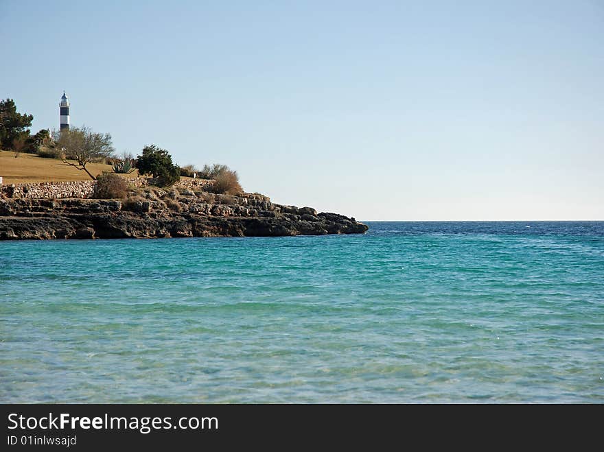 View of a beach landscape with a lighthouse Similar images on this collection. View of a beach landscape with a lighthouse Similar images on this collection