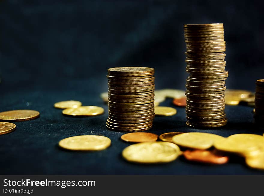 A pile of golden coins on dark background